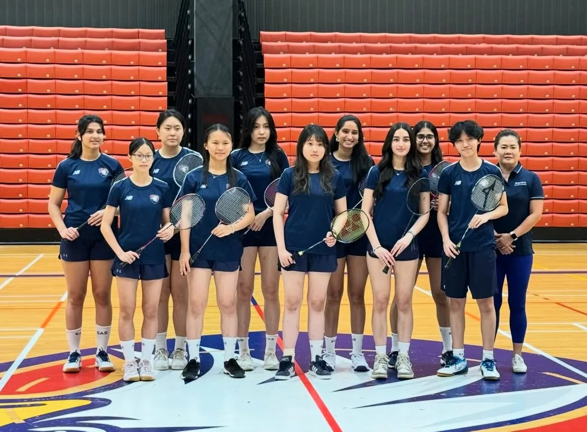 Riya with the Singapore American School IASAS badminton varsity team