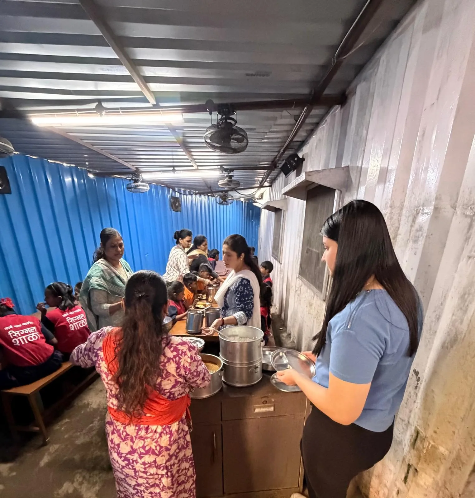 Riya serving a meal at Signal Shala, a school for children of pavement dwellers