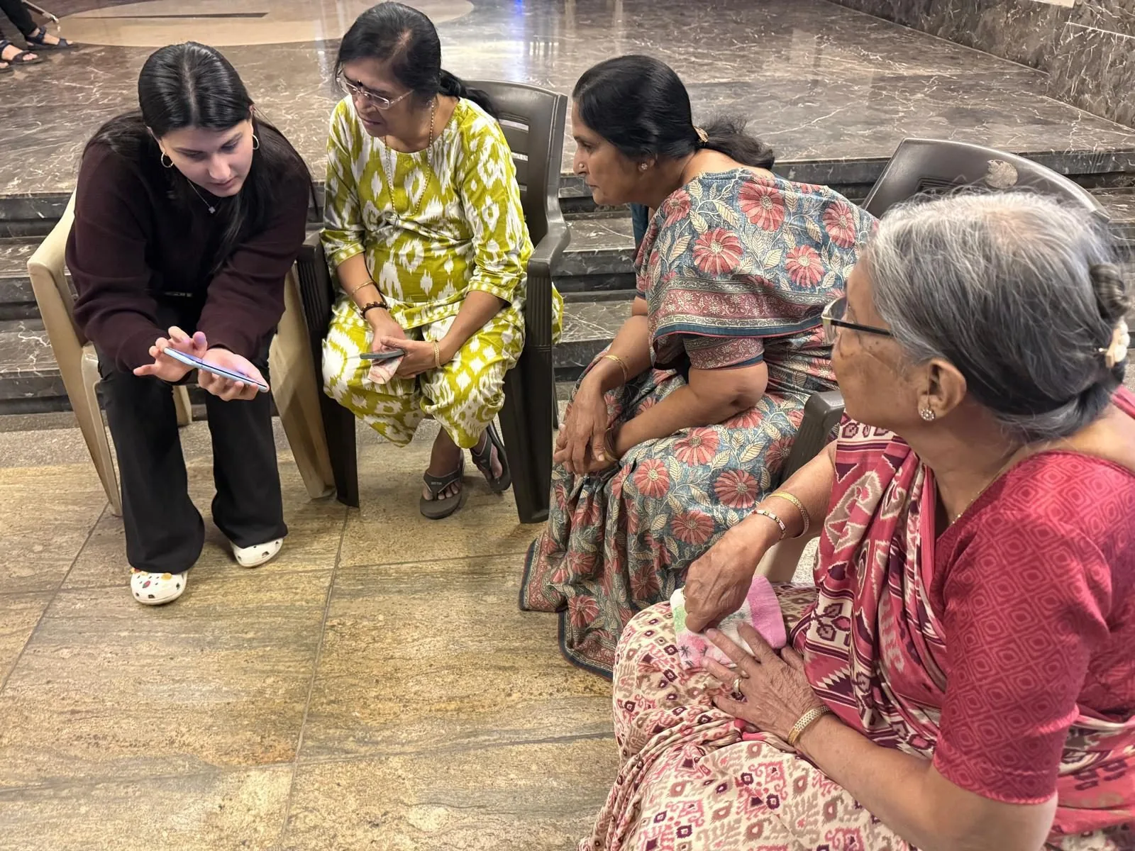 Riya walking a senior through a smartphone